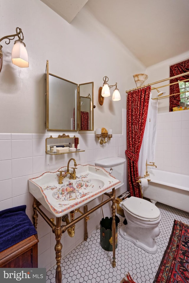 full bathroom featuring toilet, tasteful backsplash, tile walls, shower / tub combo with curtain, and tile floors