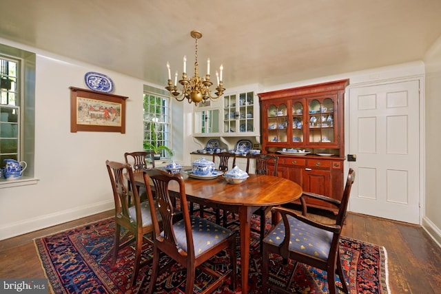 dining room featuring a notable chandelier and dark hardwood / wood-style flooring