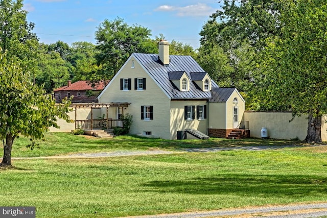 rear view of property featuring a yard