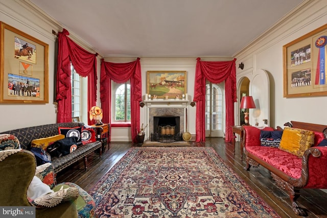 living room with ornamental molding, a high end fireplace, and dark hardwood / wood-style floors