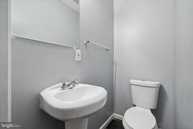 bathroom featuring toilet and tile flooring