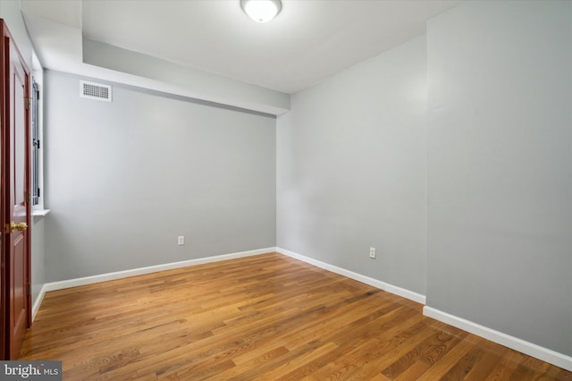 spare room with hardwood / wood-style flooring