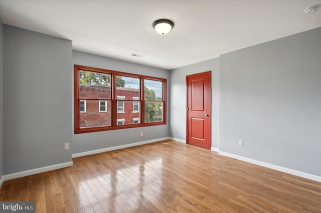 empty room with light hardwood / wood-style floors