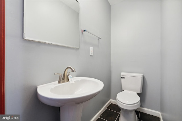 bathroom with sink, tile floors, and toilet