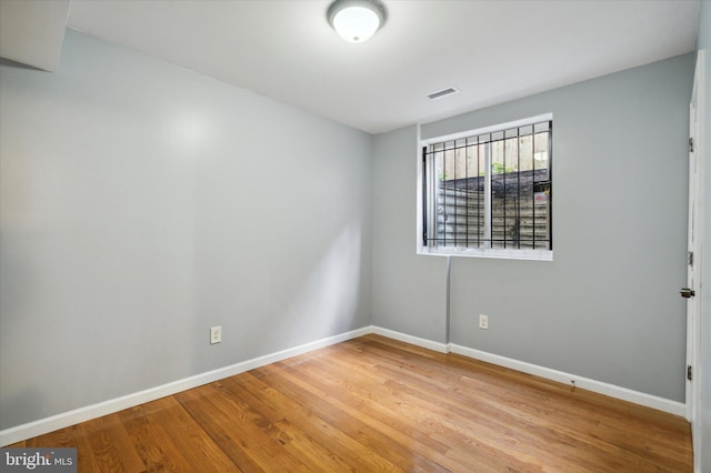 unfurnished room with light wood-type flooring