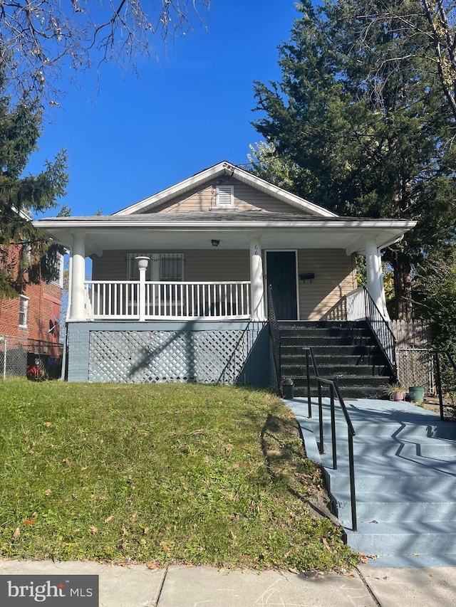 bungalow-style home with a porch and a front yard