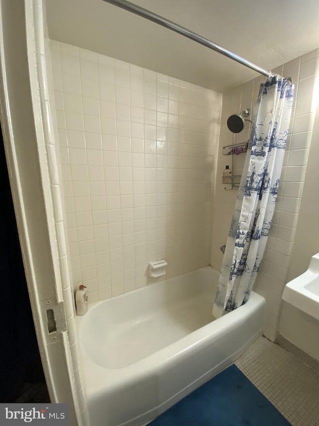 bathroom featuring shower / tub combo and tile patterned flooring