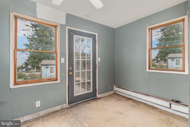 doorway to outside with a baseboard heating unit, ceiling fan, and a wealth of natural light