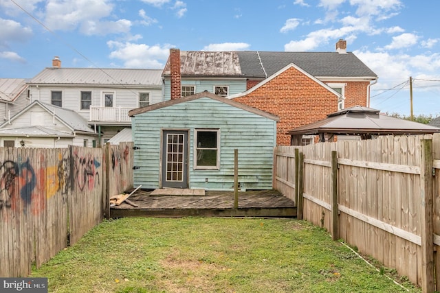 back of house with a deck, a yard, and a gazebo