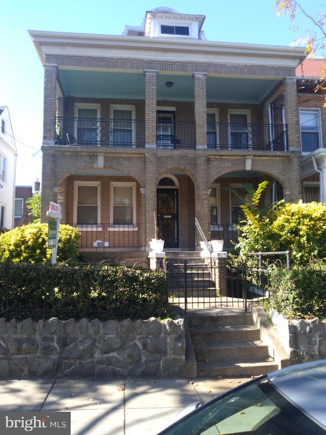 view of front of house featuring a balcony