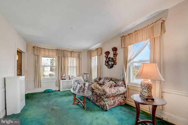 living area with plenty of natural light and dark carpet