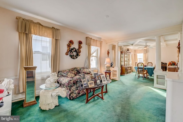 carpeted living room with ceiling fan, beamed ceiling, and ornate columns