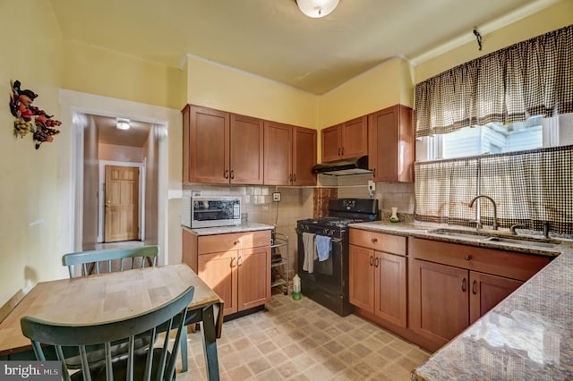 kitchen with sink, light tile floors, light stone counters, black gas range, and tasteful backsplash