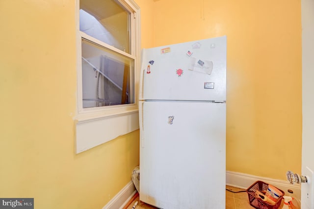 interior space featuring white refrigerator and light tile floors