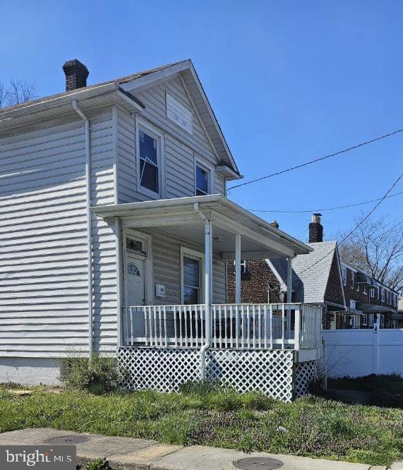 view of side of property featuring covered porch