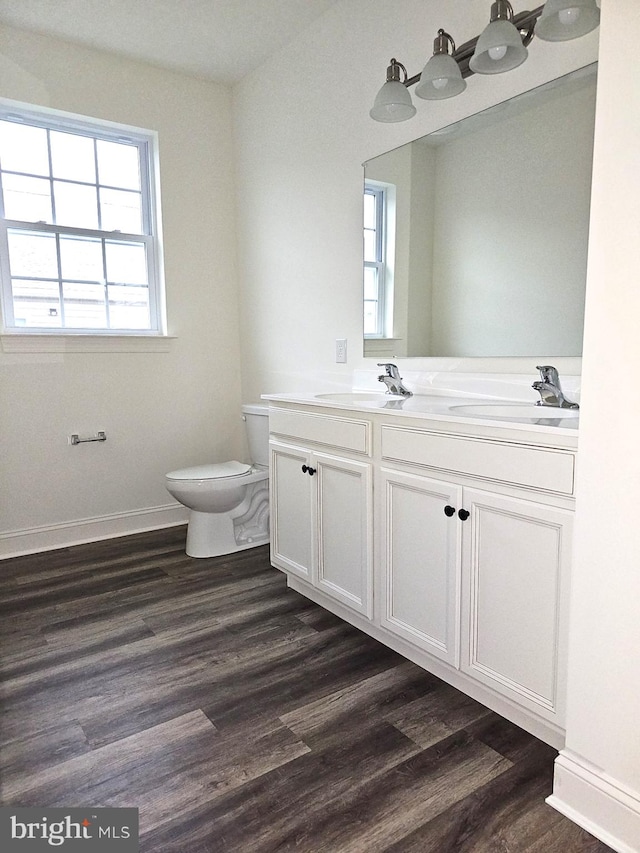 bathroom featuring hardwood / wood-style floors, a healthy amount of sunlight, and toilet