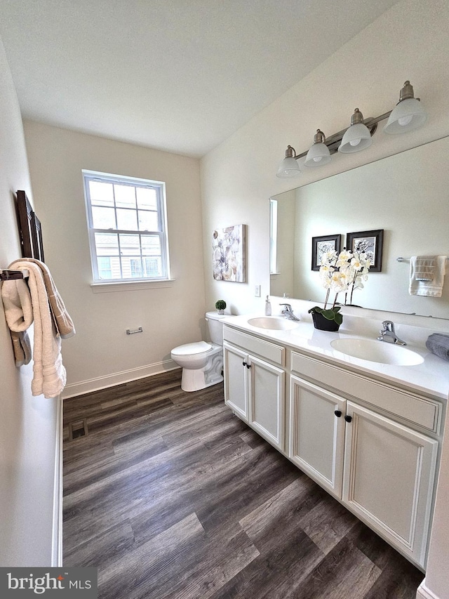 bathroom featuring vanity, toilet, and wood-type flooring