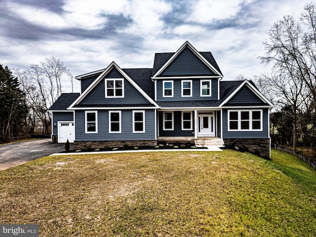 craftsman inspired home with a garage and a front yard