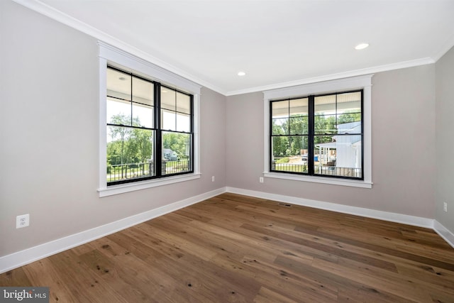 unfurnished room with dark hardwood / wood-style flooring and crown molding