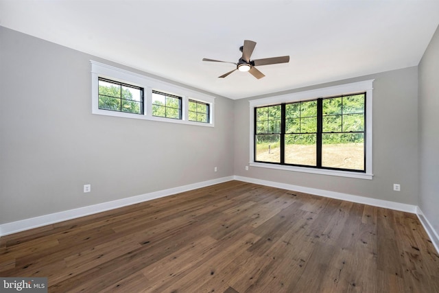 spare room featuring dark hardwood / wood-style floors and ceiling fan