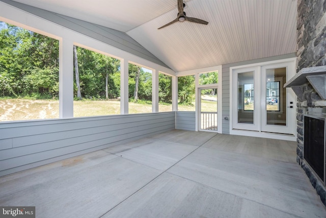 unfurnished sunroom with ceiling fan and vaulted ceiling