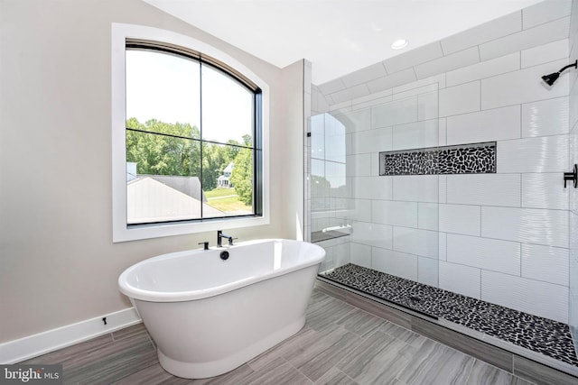 bathroom with separate shower and tub