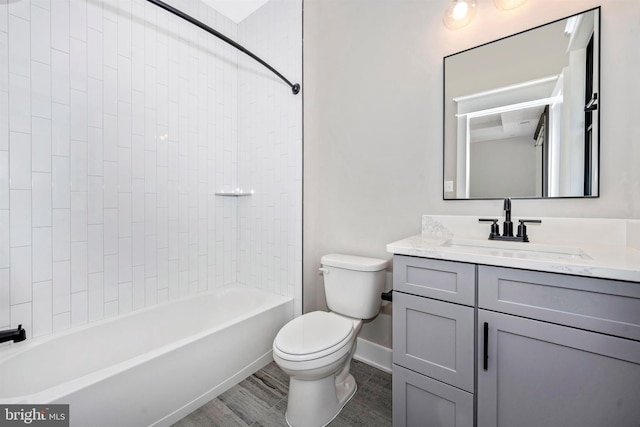 full bathroom with vanity, wood-type flooring, tiled shower / bath, and toilet