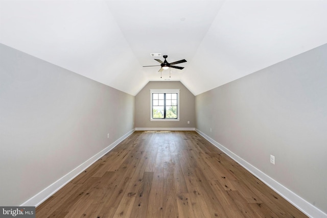 additional living space featuring lofted ceiling, hardwood / wood-style floors, and ceiling fan