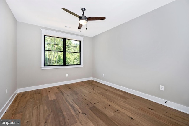 empty room with ceiling fan and hardwood / wood-style floors