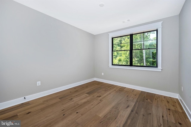 spare room with hardwood / wood-style flooring