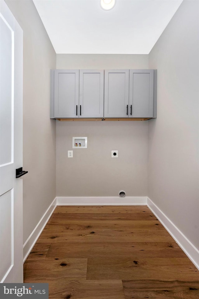 laundry area featuring cabinets, washer hookup, hookup for an electric dryer, and dark hardwood / wood-style flooring