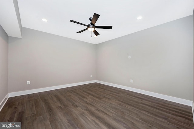 empty room featuring ceiling fan and dark hardwood / wood-style flooring