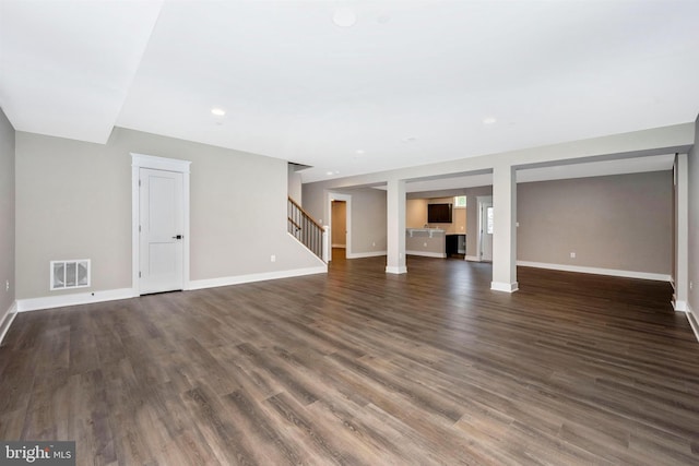 basement with dark hardwood / wood-style flooring