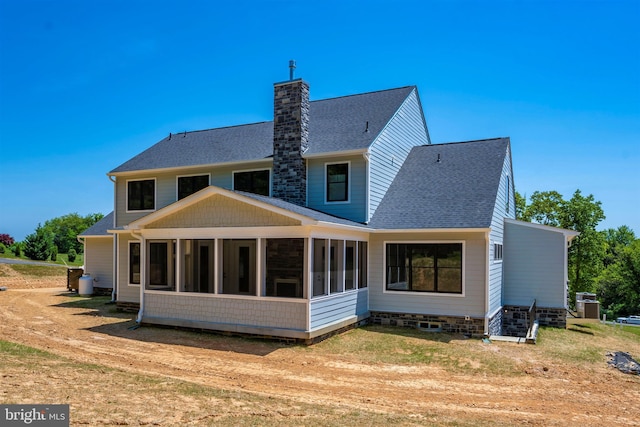 rear view of property featuring a sunroom