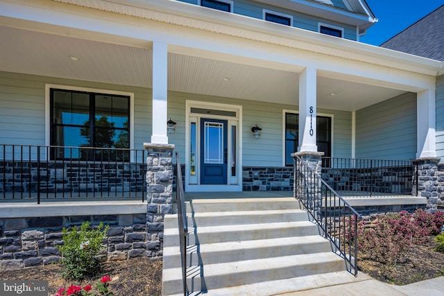 view of exterior entry featuring a porch