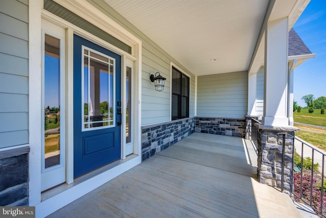 entrance to property featuring a porch