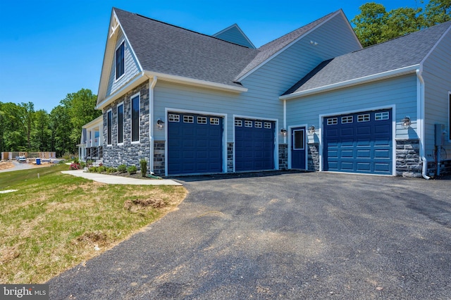 view of side of property with a yard and a garage