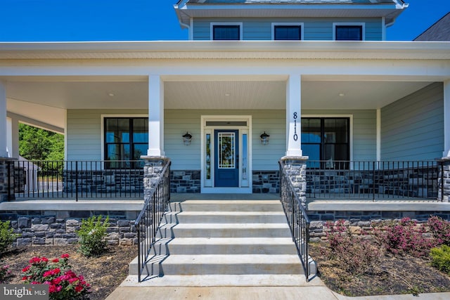 view of exterior entry with covered porch