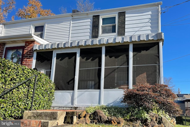 view of side of property with a sunroom