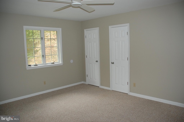 unfurnished bedroom with light colored carpet and ceiling fan