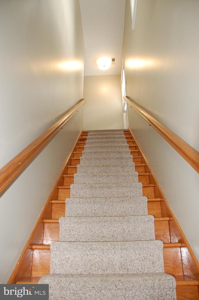 stairway with light wood-type flooring