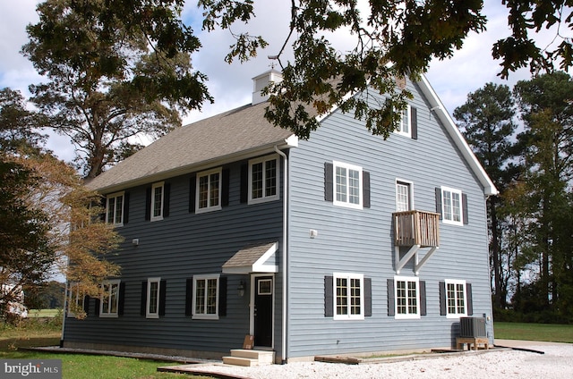 rear view of house with central AC