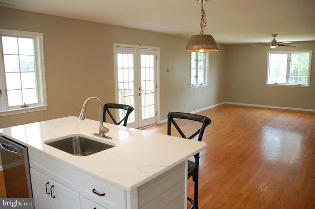 kitchen with a wealth of natural light, decorative light fixtures, and sink