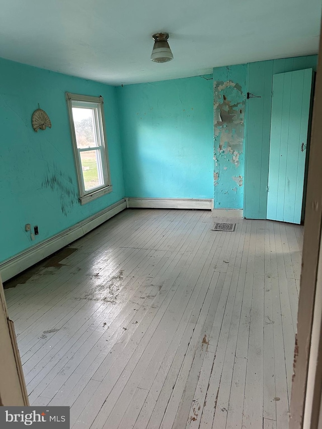 spare room with light hardwood / wood-style flooring and baseboard heating