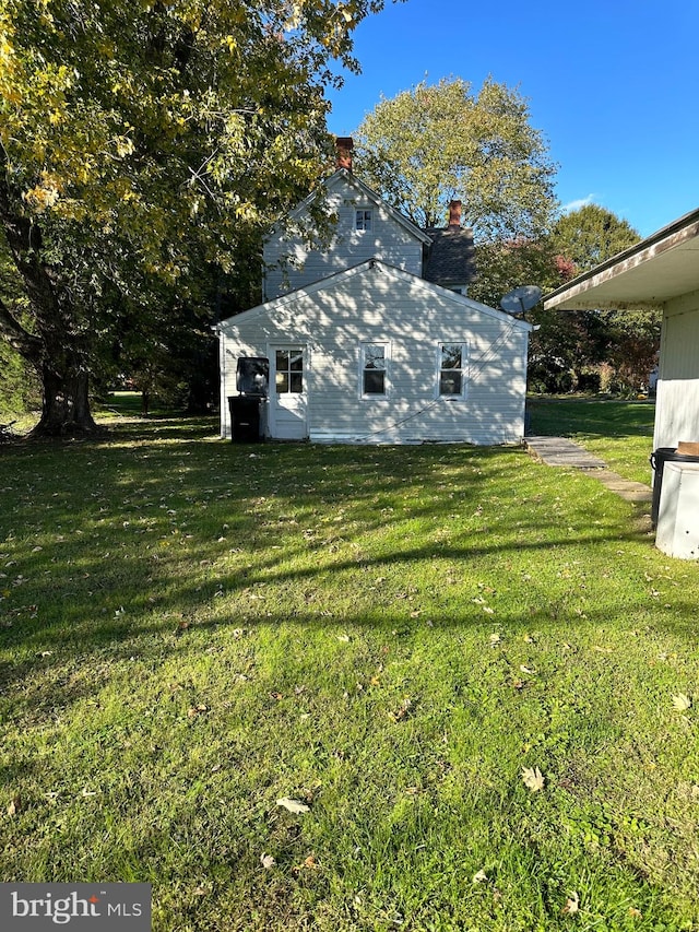 view of home's exterior with a yard