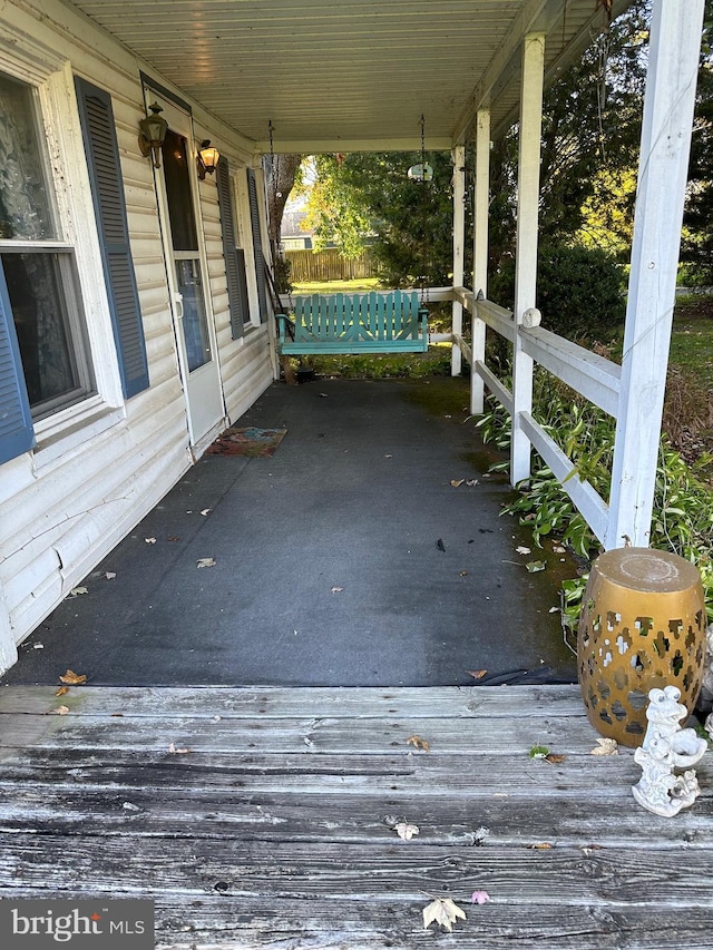 wooden terrace featuring covered porch