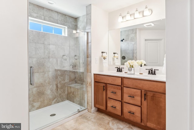 bathroom with double sink, tile flooring, a shower with shower door, and oversized vanity