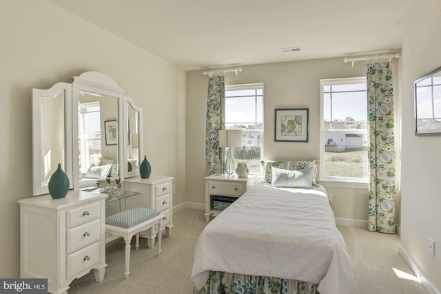 bedroom featuring light colored carpet