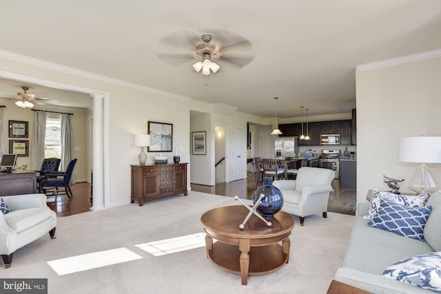 living room with ceiling fan, light hardwood / wood-style floors, and ornamental molding