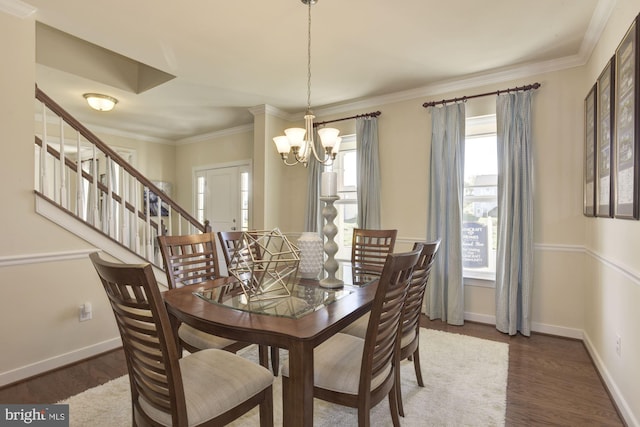 dining room with ornamental molding, an inviting chandelier, and dark wood-type flooring